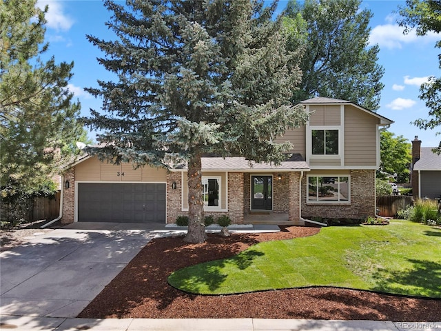 34 Honey Locust, Littleton, CO 80127 - view of front of home featuring a garage, driveway, and brick siding
