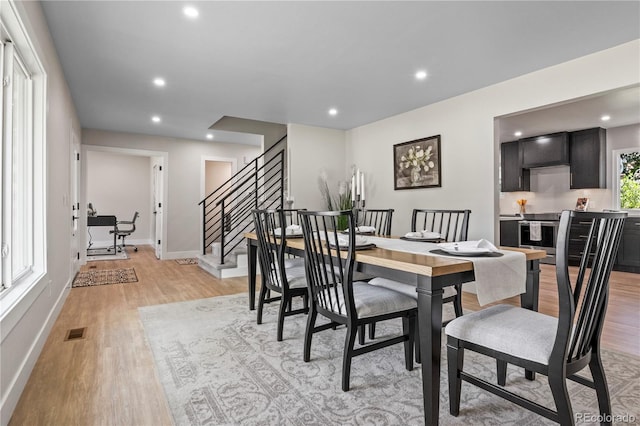 34 Honey Locust, Littleton, CO 80127 - dining area with light wood-style flooring, recessed lighting, and stairs