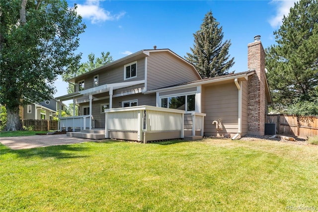 34 Honey Locust, Littleton, CO 80127 - back of house with a chimney, a wooden deck, and a patio area