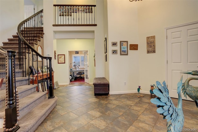 entrance foyer featuring a towering ceiling