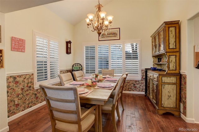 dining room featuring vaulted ceiling, dark hardwood / wood-style flooring, and an inviting chandelier