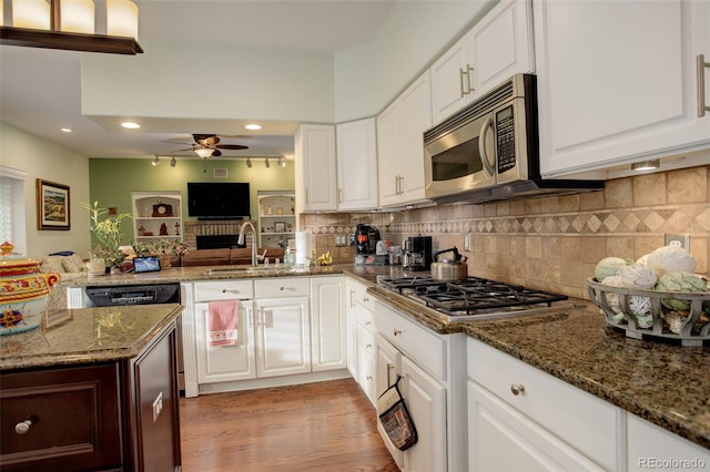 kitchen with white cabinetry, sink, ceiling fan, dark stone countertops, and appliances with stainless steel finishes