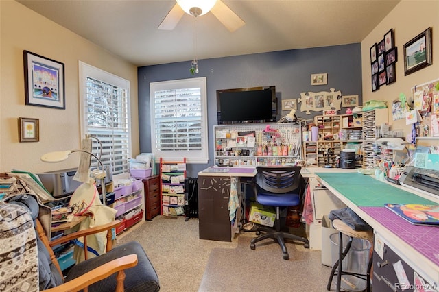 carpeted office space featuring ceiling fan