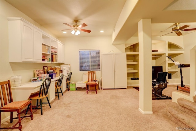 recreation room with ceiling fan, built in features, and light colored carpet