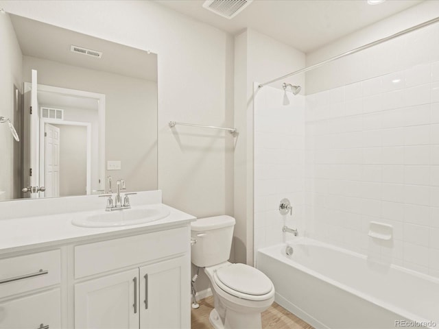 full bathroom with wood-type flooring, vanity, toilet, and tiled shower / bath