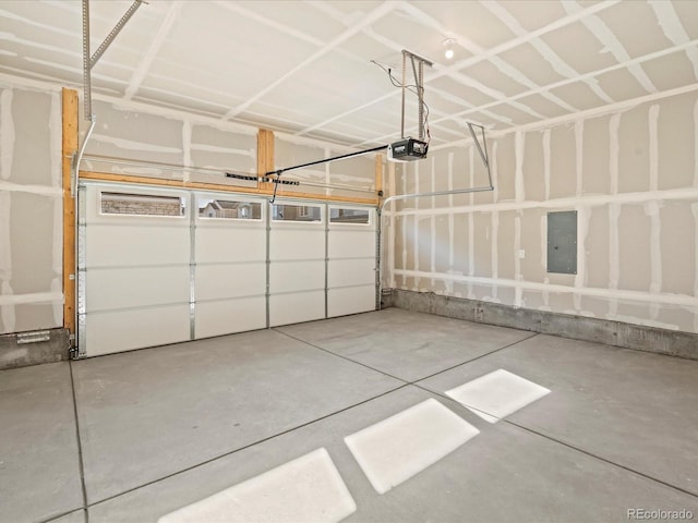 garage with electric panel and a garage door opener