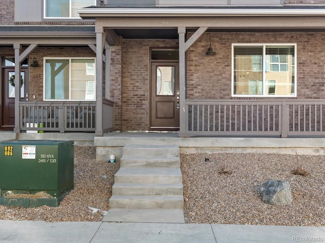 view of exterior entry with covered porch