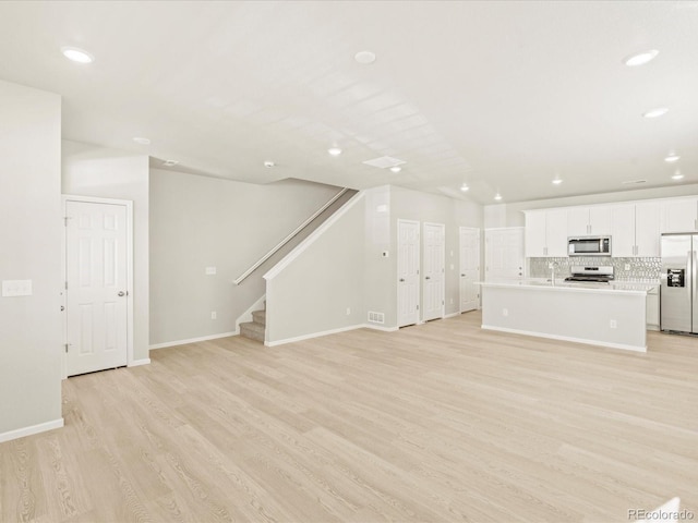 unfurnished living room with light wood-type flooring