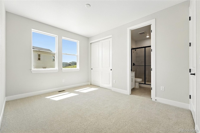 1672 Fox Trotter Pt, Castle Rock, CO 80104 - unfurnished bedroom featuring carpet flooring, connected bathroom, and a closet