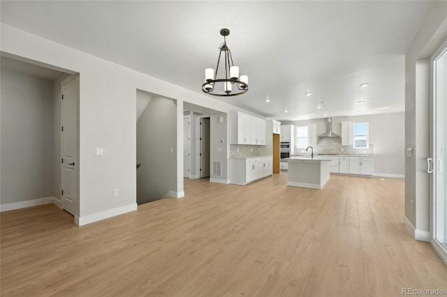 1672 Fox Trotter Pt, Castle Rock, CO 80104 - unfurnished living room with a chandelier, light wood finished floors, and recessed lighting