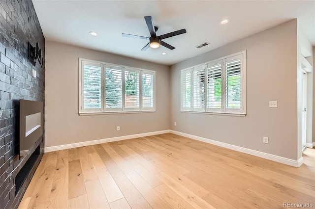 606 E Dry Creek Pl, Littleton, CO 80122 - unfurnished room with ceiling fan, light wood finished floors, a large fireplace, and recessed lighting