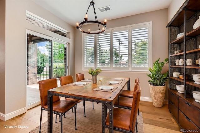606 E Dry Creek Pl, Littleton, CO 80122 - dining area featuring a chandelier, healthy amount of natural light, and light wood-style flooring