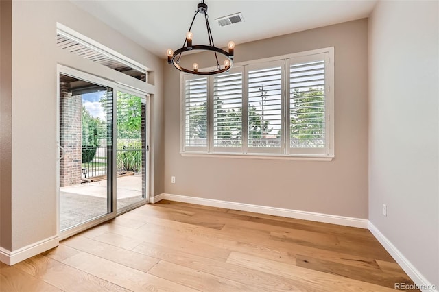 606 E Dry Creek Pl, Littleton, CO 80122 - unfurnished dining area with a chandelier, healthy amount of natural light, and light wood-type flooring
