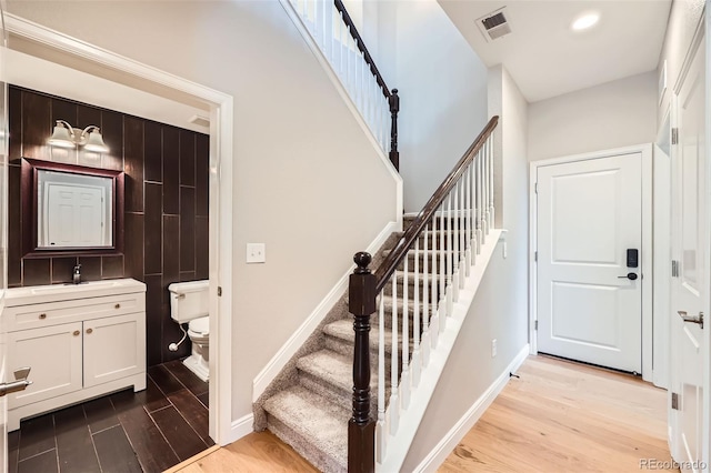 606 E Dry Creek Pl, Littleton, CO 80122 - stairway with wood finished floors and recessed lighting