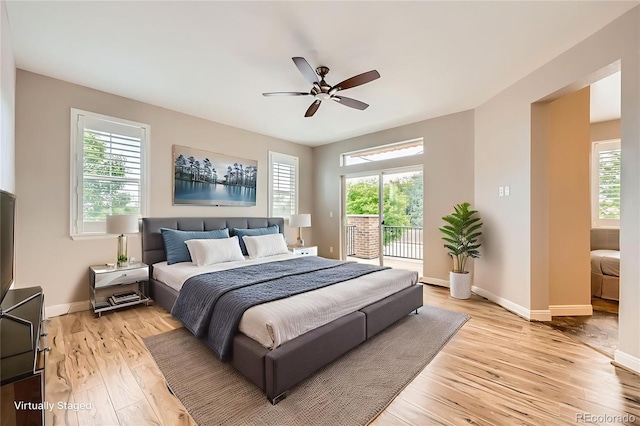 606 E Dry Creek Pl, Littleton, CO 80122 - bedroom with access to exterior, multiple windows, light wood-style floors, and ceiling fan
