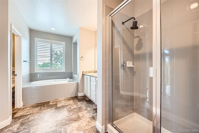 606 E Dry Creek Pl, Littleton, CO 80122 - full bathroom with a stall shower, vanity, and a bath