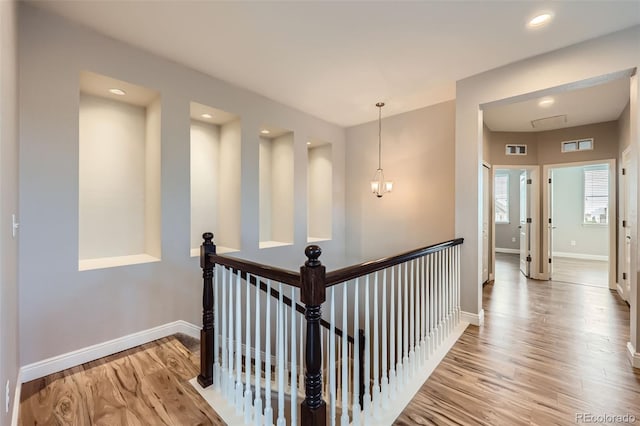 606 E Dry Creek Pl, Littleton, CO 80122 - hall with wood finished floors, an upstairs landing, and recessed lighting
