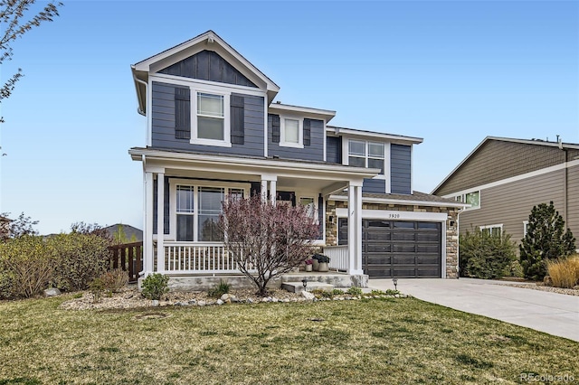 traditional-style house with covered porch, board and batten siding, concrete driveway, and a front yard