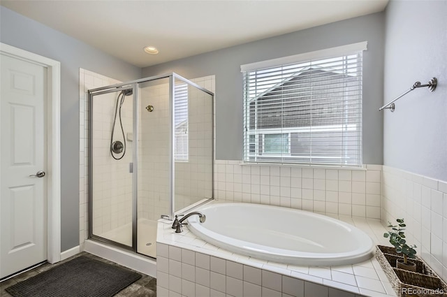 full bath featuring recessed lighting, a bath, and a stall shower