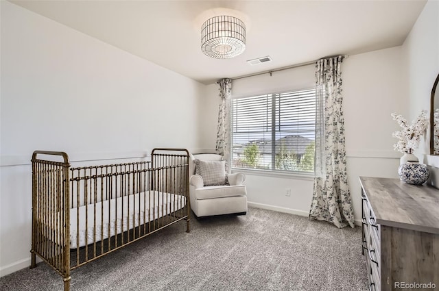 bedroom featuring carpet flooring, a nursery area, baseboards, and visible vents