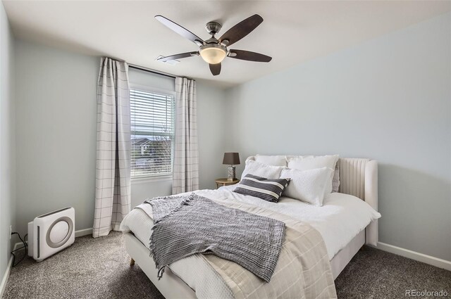 carpeted bedroom with a ceiling fan and baseboards