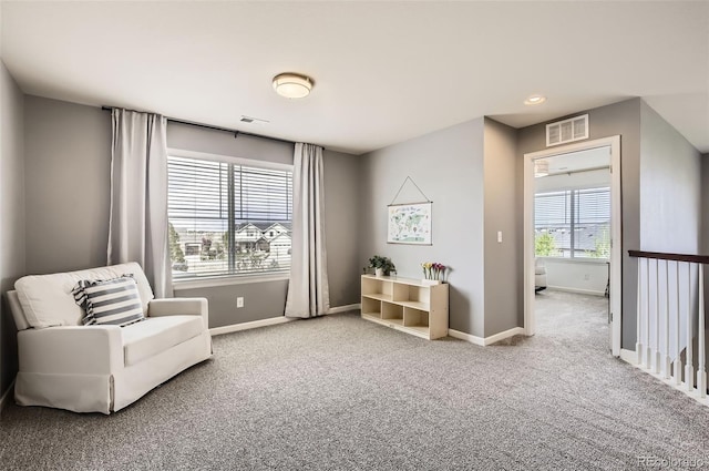 living area featuring recessed lighting, baseboards, visible vents, and carpet