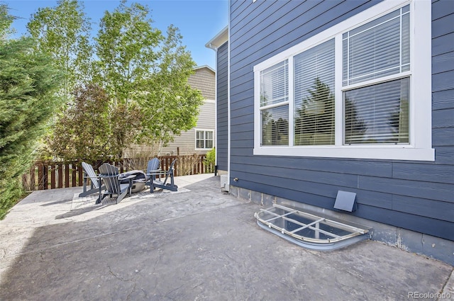 view of patio / terrace featuring an outdoor fire pit and fence