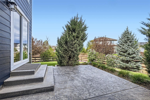 view of patio / terrace featuring fence