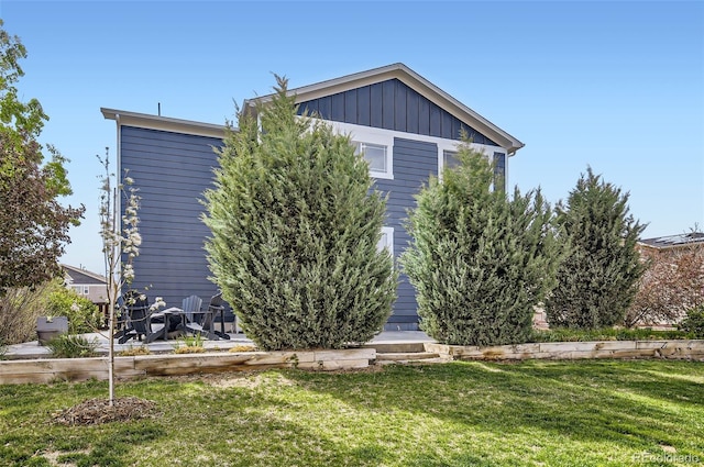 view of side of home featuring a yard