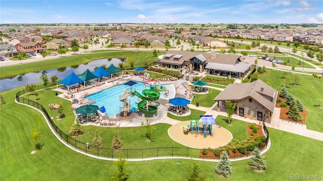 birds eye view of property with a water view and a residential view