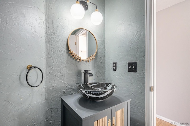 bathroom with hardwood / wood-style flooring and vanity