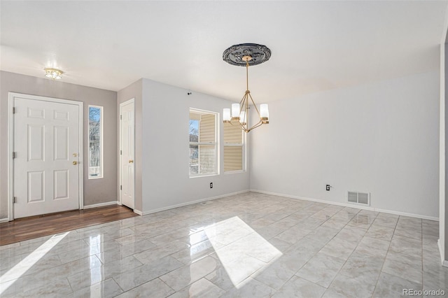 entrance foyer featuring an inviting chandelier