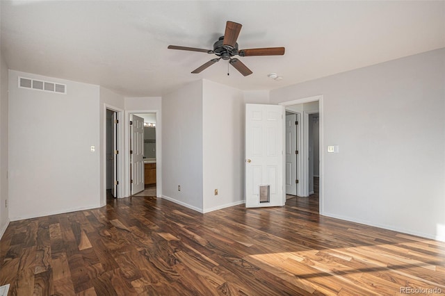 empty room with ceiling fan and dark hardwood / wood-style flooring