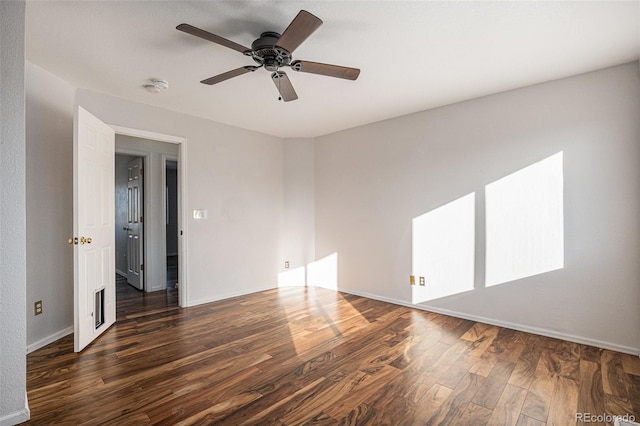 empty room with dark hardwood / wood-style floors and ceiling fan