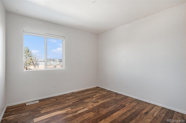 spare room with dark hardwood / wood-style floors