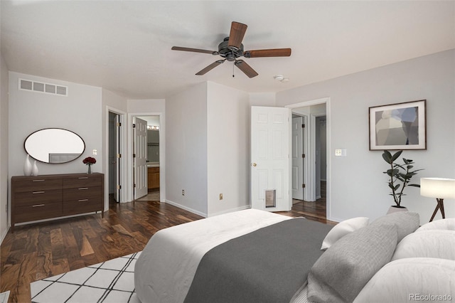 bedroom featuring dark hardwood / wood-style flooring, ensuite bathroom, and ceiling fan