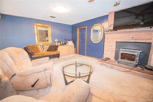 living area featuring visible vents, ceiling fan, and carpet