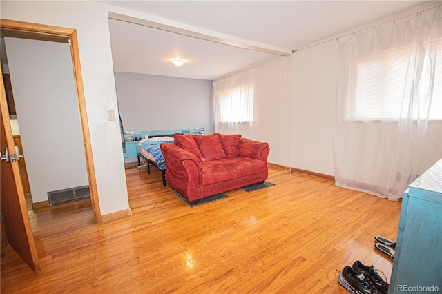 living room featuring visible vents, wood finished floors, and baseboards