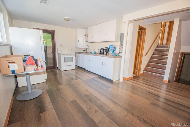 kitchen featuring a sink, white cabinetry, dark wood finished floors, baseboards, and white appliances