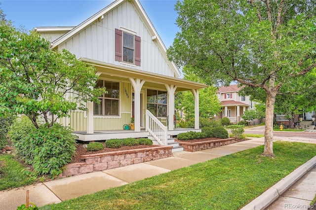 10193 E 29th Ave, Denver, CO 80238 - view of front of house with board and batten siding, covered porch, and a front lawn