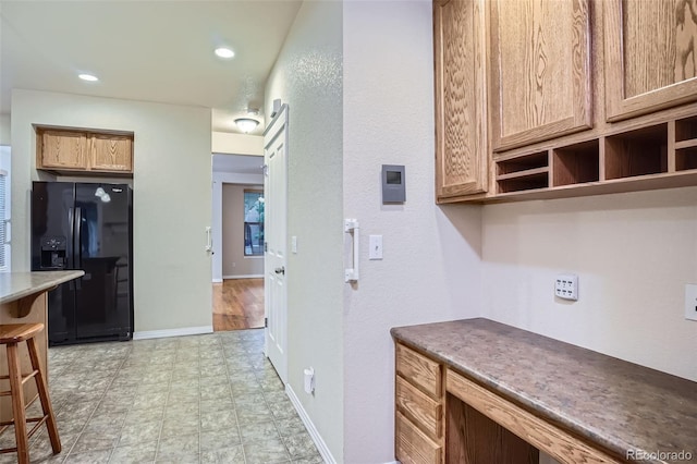 10193 E 29th Ave, Denver, CO 80238 - kitchen featuring black fridge, a kitchen bar, and recessed lighting