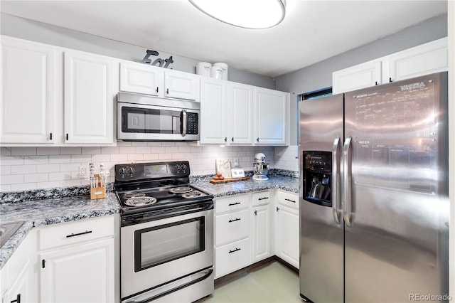 8787 W Cornell Ave Unit 6, Lakewood, CO 80227 - kitchen featuring appliances with stainless steel finishes, white cabinets, tasteful backsplash, and light stone counters