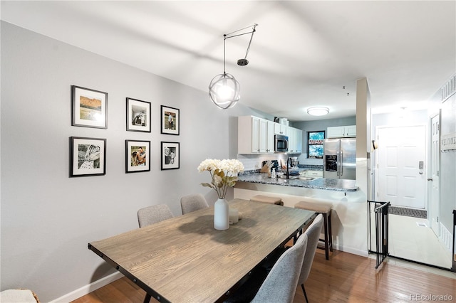 8787 W Cornell Ave Unit 6, Lakewood, CO 80227 - dining area featuring light wood-style floors and baseboards