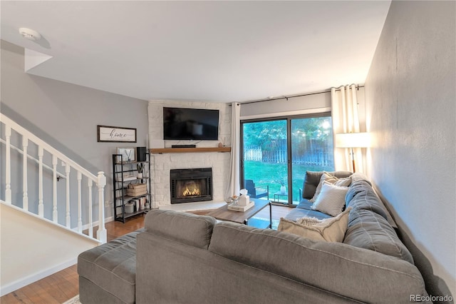 8787 W Cornell Ave Unit 6, Lakewood, CO 80227 - living room featuring wood finished floors, stairway, baseboards, and a fireplace