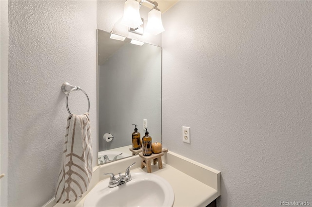 8787 W Cornell Ave Unit 6, Lakewood, CO 80227 - bathroom with a textured wall and vanity