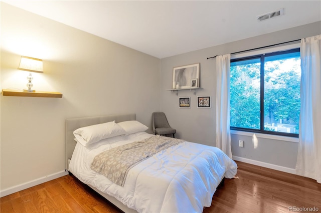 8787 W Cornell Ave Unit 6, Lakewood, CO 80227 - bedroom with baseboards, multiple windows, and wood finished floors