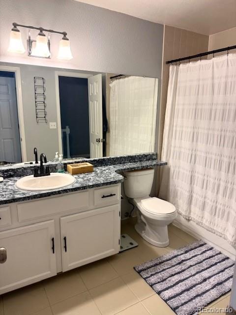8787 W Cornell Ave Unit 6, Lakewood, CO 80227 - full bathroom featuring tile patterned flooring, vanity, toilet, and a shower with curtain
