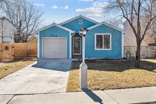 view of front facade with a front lawn, fence, driveway, and an attached garage