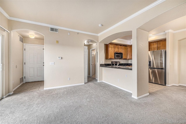 kitchen with light carpet, stainless steel fridge, crown molding, and sink