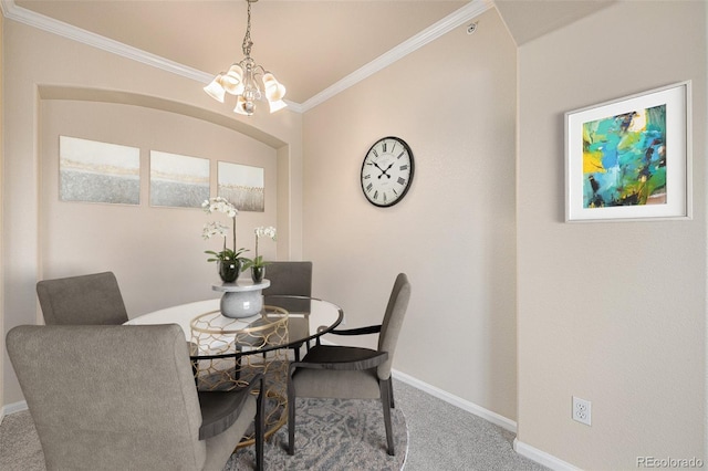 carpeted dining area featuring crown molding and a notable chandelier